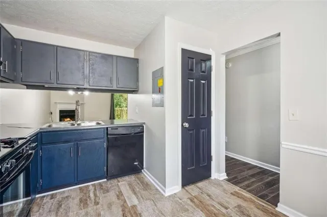 a kitchen with a refrigerator and a stove top oven