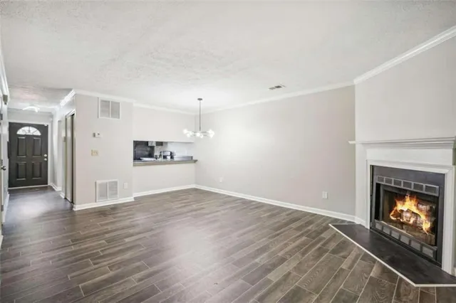 a view of an empty room with a fireplace and a window
