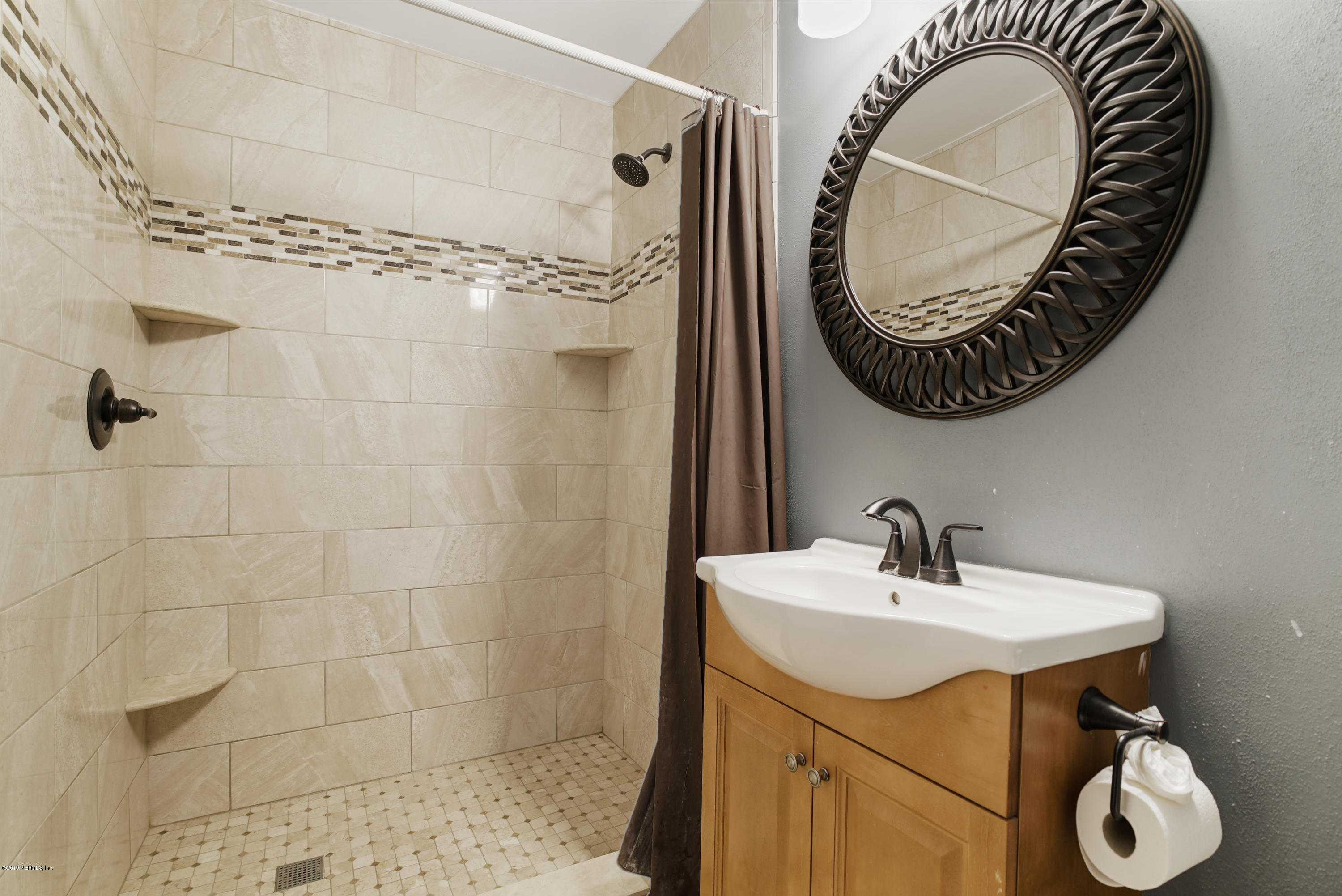 116 Harvard Road St. Augustine, FL 32086 - Photo 3 of 18 a bathroom with a sink and a mirror
