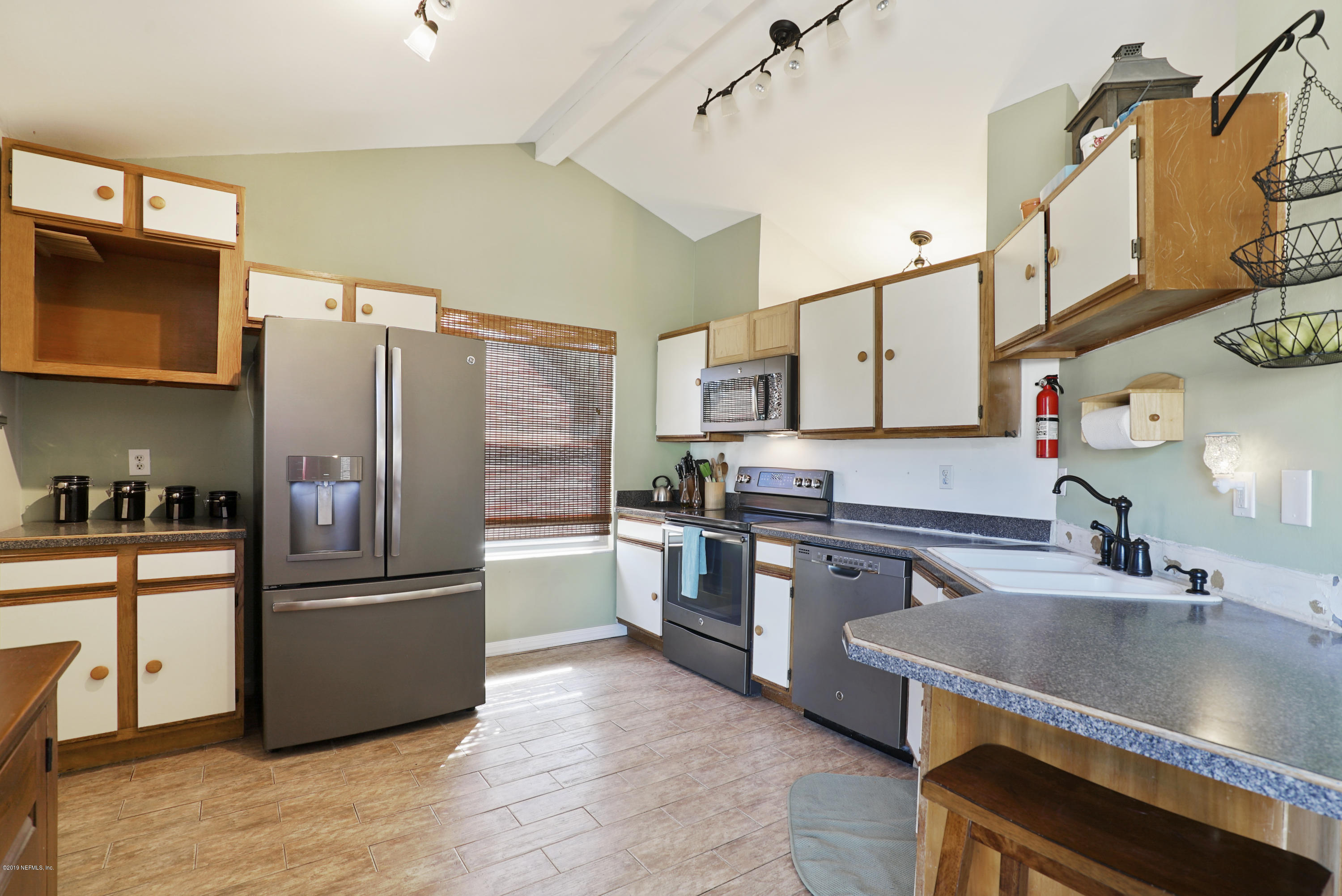 116 Harvard Road St. Augustine, FL 32086 - Photo 7 of 18 a kitchen with stainless steel appliances granite countertop a sink stove and refrigerator