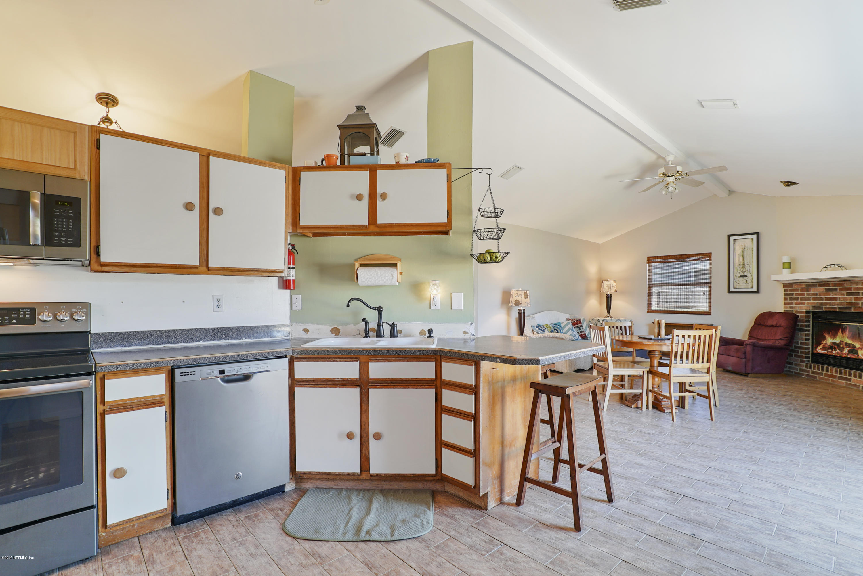 116 Harvard Road St. Augustine, FL 32086 - Photo 8 of 18 a kitchen with a table chairs stove and cabinets