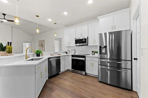 a kitchen with a refrigerator sink and stainless steel appliances