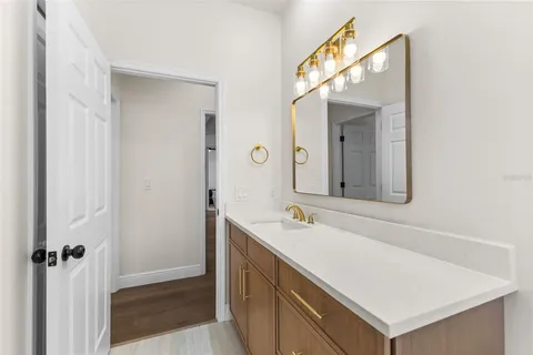 a bathroom with a sink vanity and a mirror