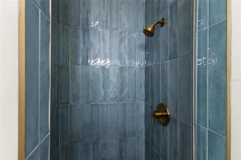 an empty room with wooden floor cabinet and windows