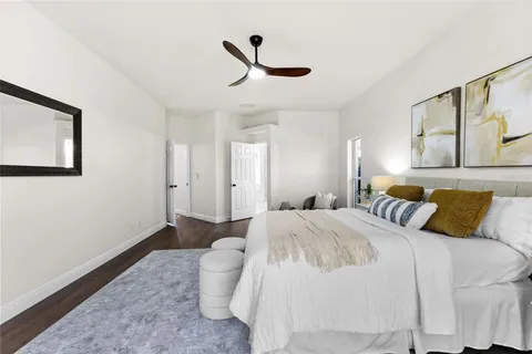 a bedroom with a bed and a painting on the wall