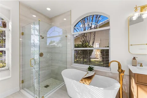 a bathroom with a sink a bathtub and shower