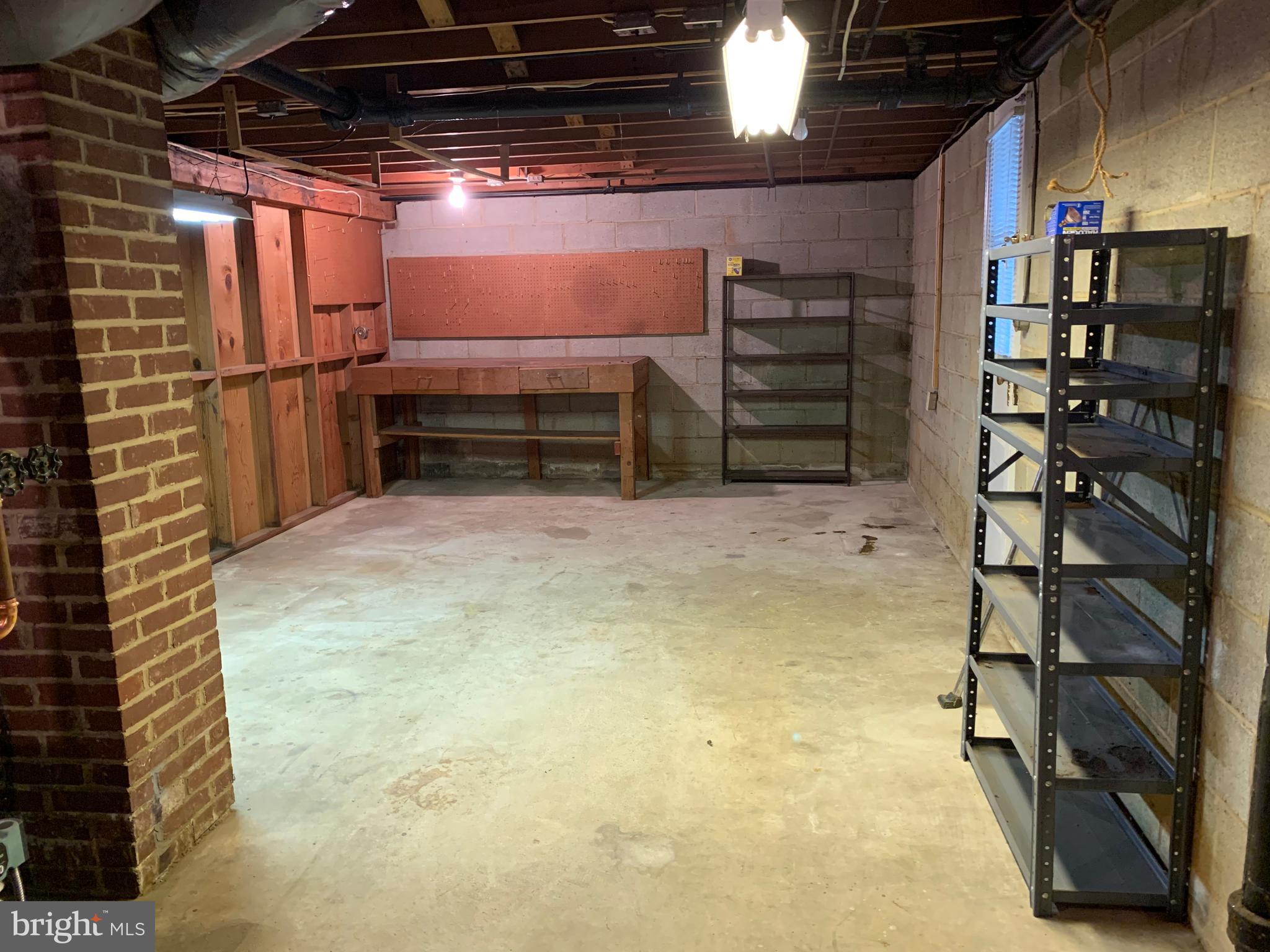 205 Delight Road Reisterstown, MD 21136 - Photo 14 of 26 Workroom with Shelving and Workbench
