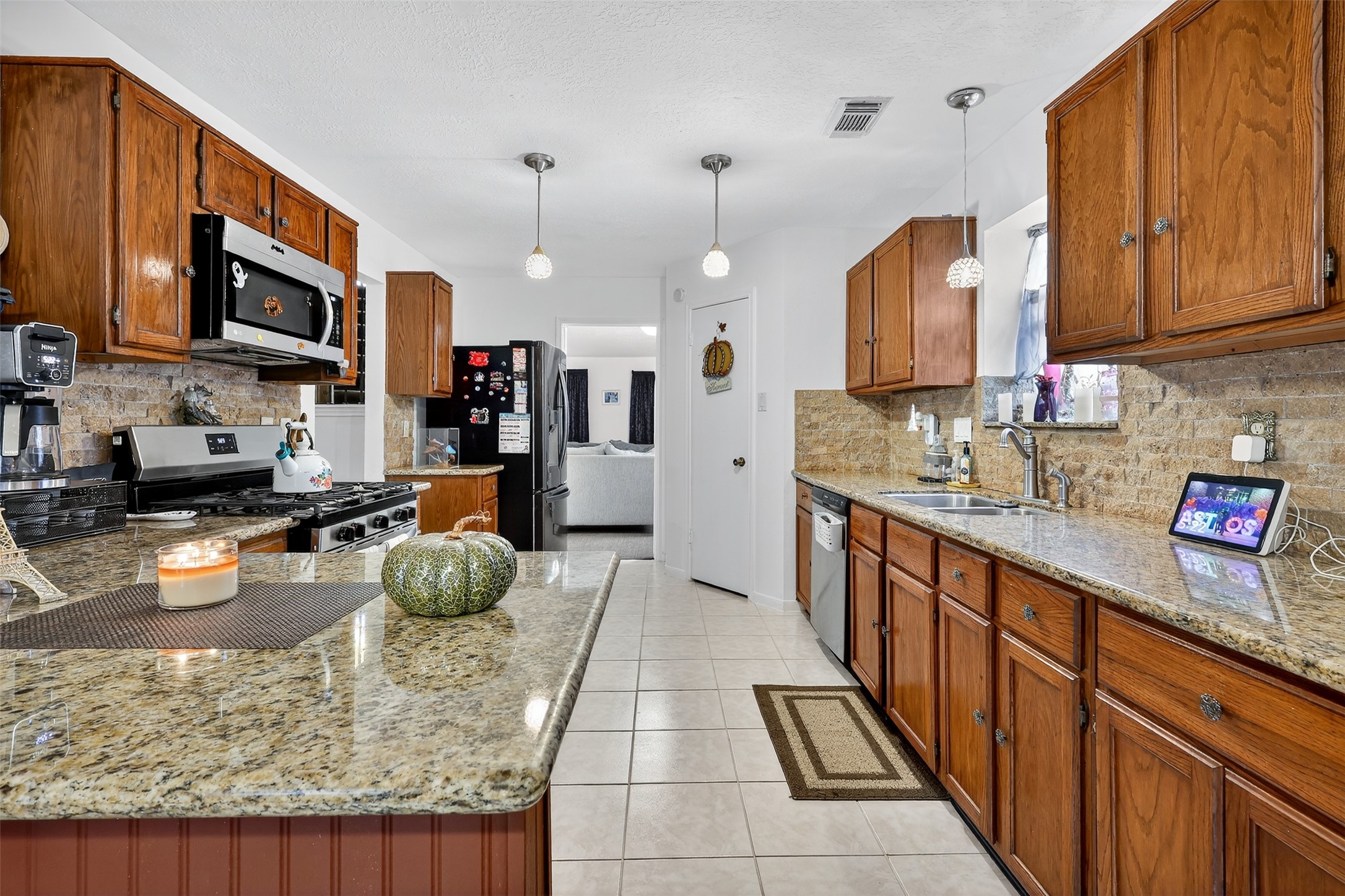 3402 Crystal Dove Drive Spring, TX 77388 - Photo 9 of 33 a kitchen with stainless steel appliances granite countertop a sink stove and refrigerator