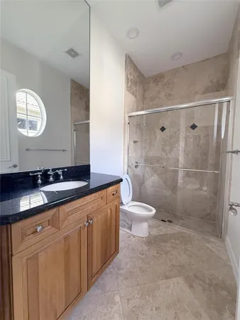 a bathroom with a double vanity sink toilet and shower