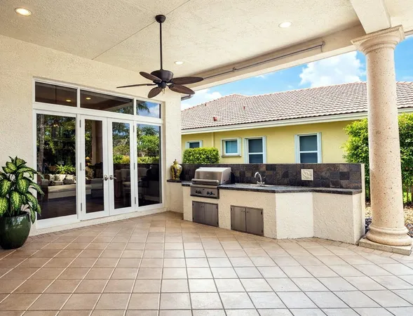 a kitchen with stainless steel appliances granite countertop a sink and a refrigerator