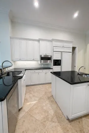 a kitchen with stainless steel appliances a sink a stove and cabinets