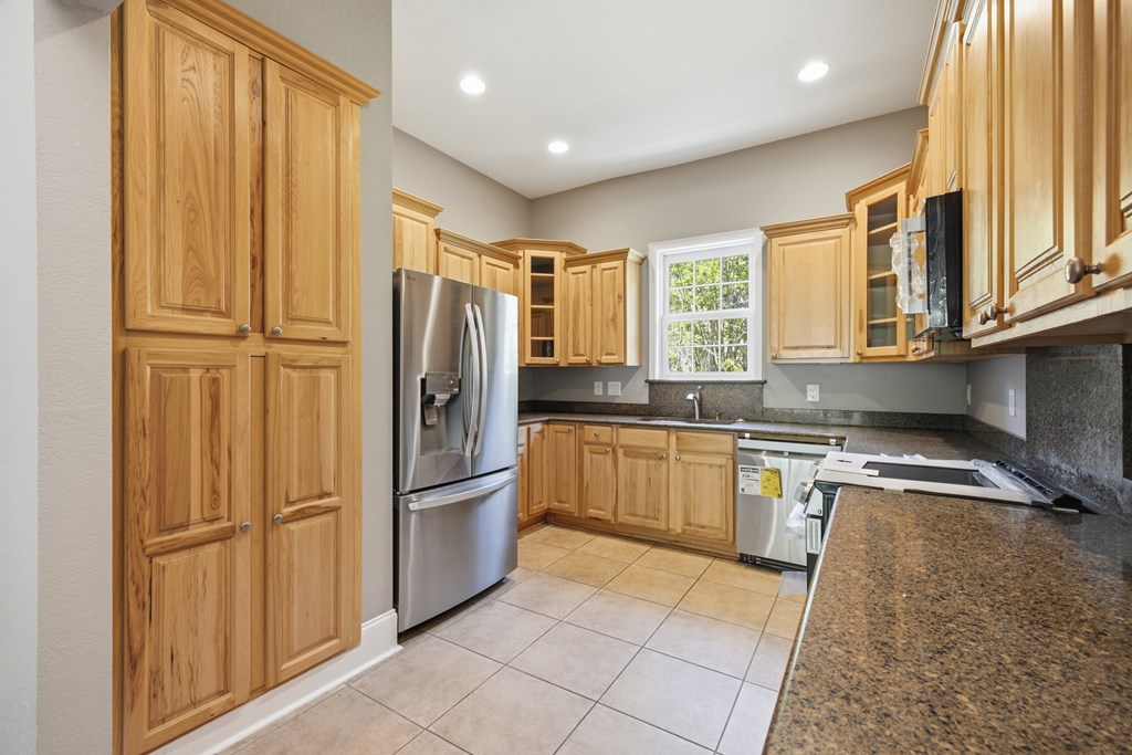 2143 Ridgecrest Circle, Unit 1 Hiawassee, GA 30546 - Photo 40 of 53 a kitchen with stainless steel appliances granite countertop a refrigerator and a sink