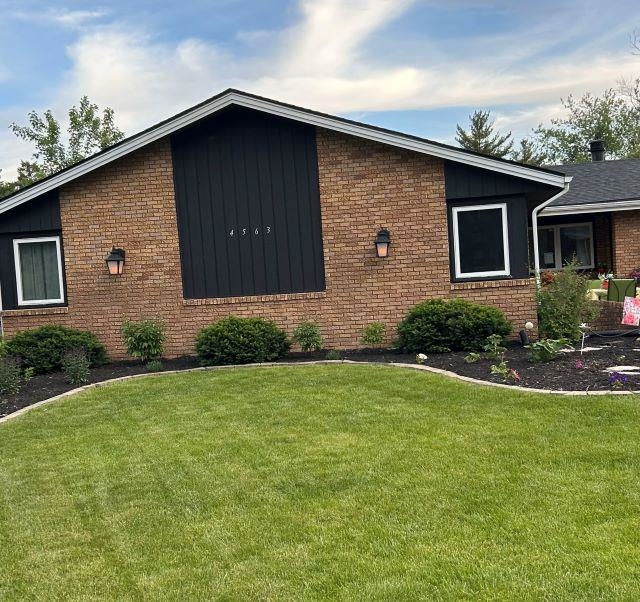 4563 Sunderman Road Rockford, IL 61114 - Photo 1 of 70 a brick house with a yard plants in front of it