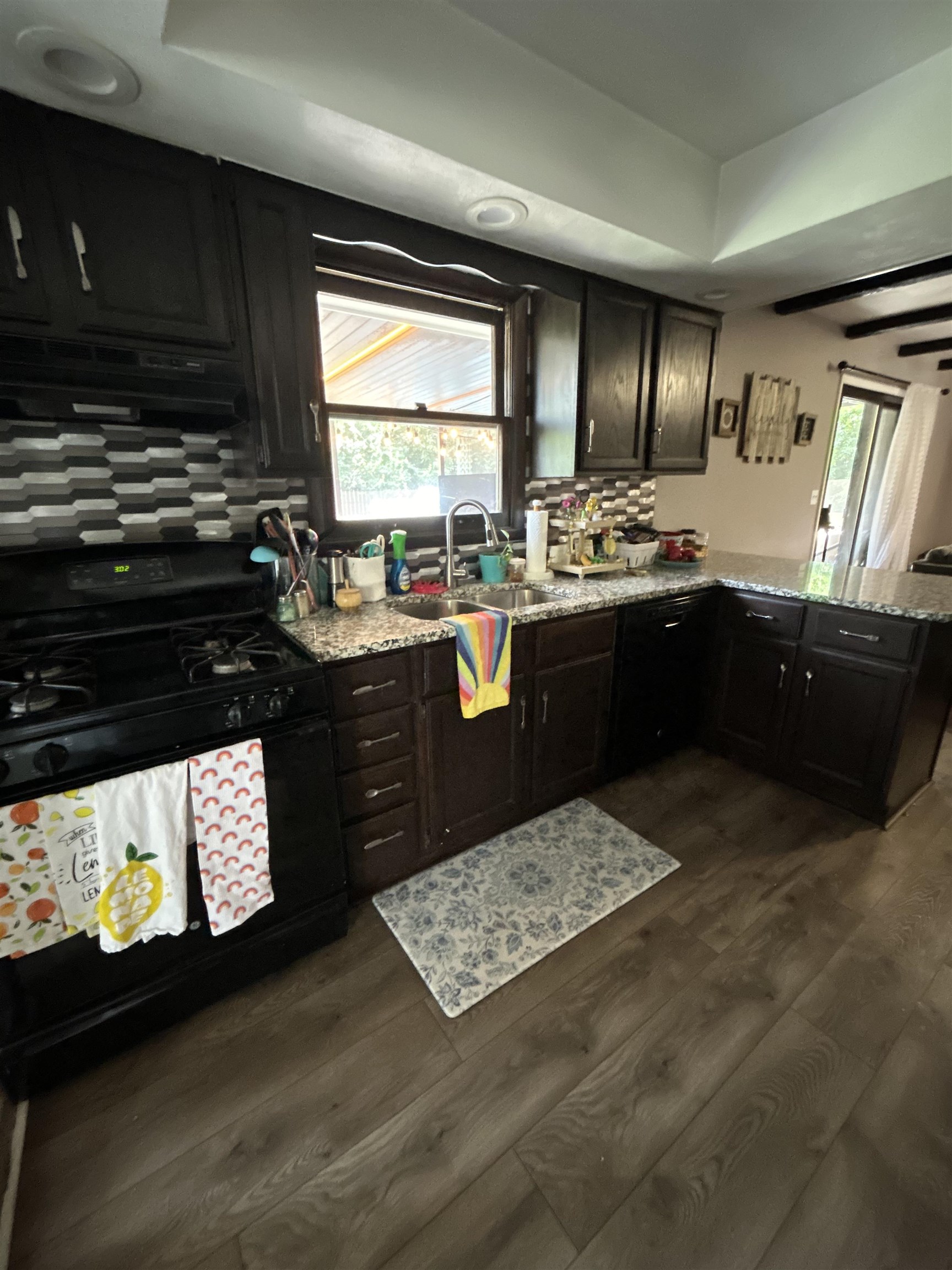 4563 Sunderman Road Rockford, IL 61114 - Photo 38 of 70 a kitchen with granite countertop a stove a sink and a microwave