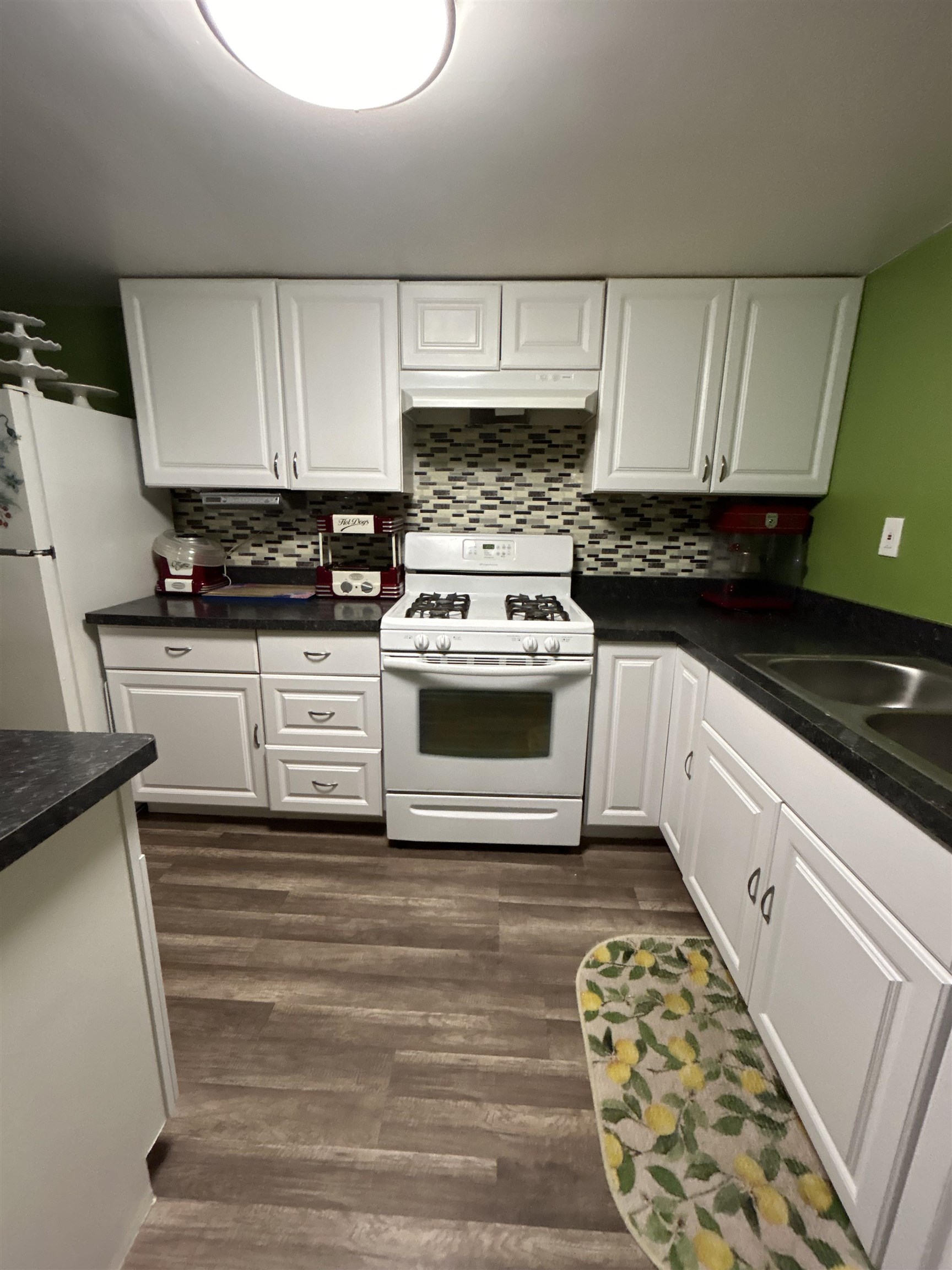 4563 Sunderman Road Rockford, IL 61114 - Photo 55 of 70 a kitchen with granite countertop a sink and a stove top oven