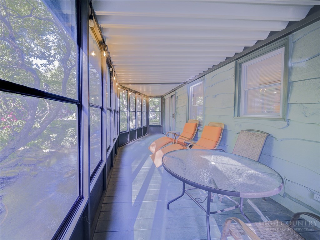 1471 Bamboo Road Boone, NC 28607 - Photo 15 of 19 a balcony with chairs and wooden floor