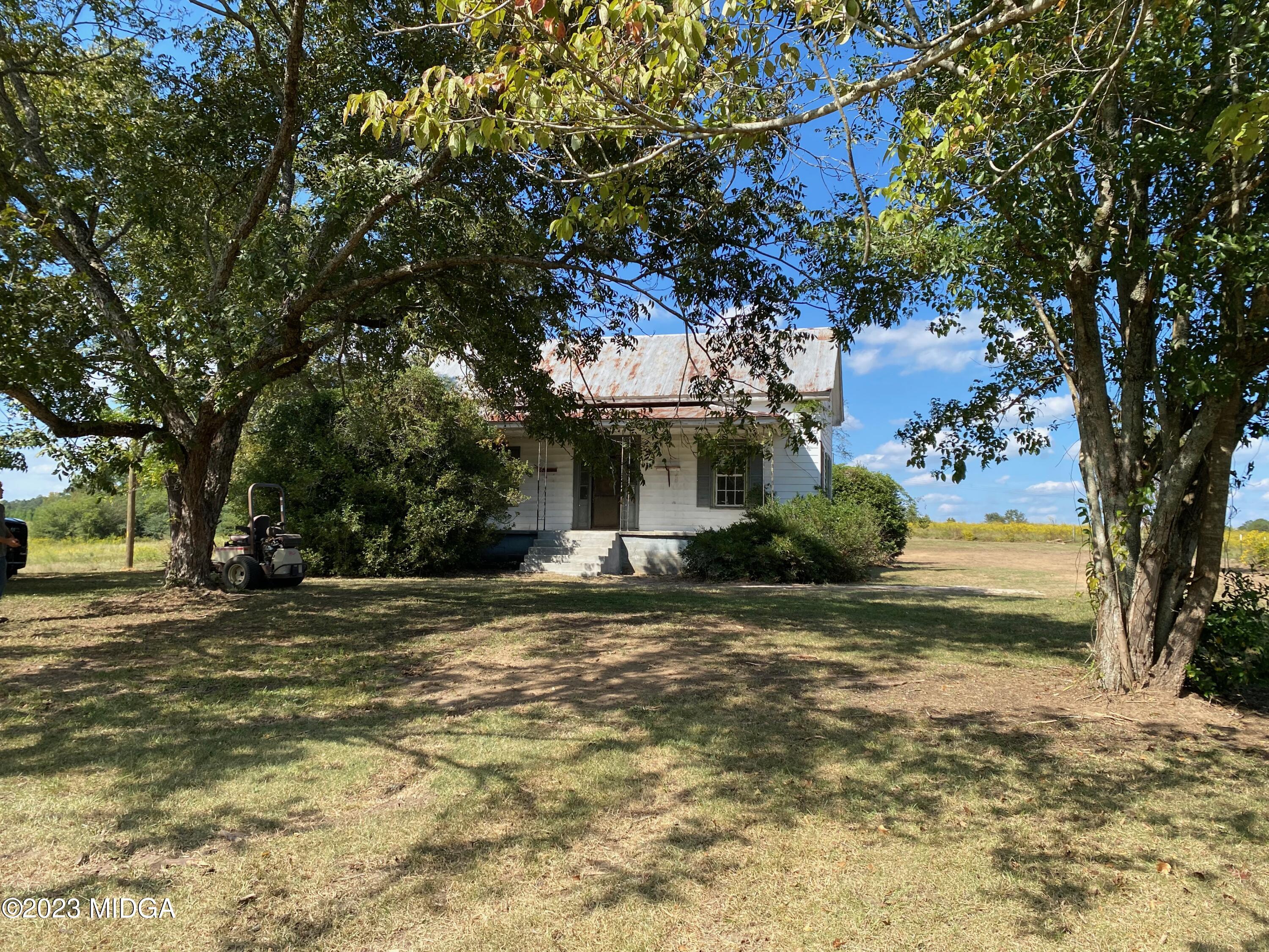 491 Barrow Road Reynolds, GA 31076 - Photo 24 of 56 a view of a house with a tree in the background