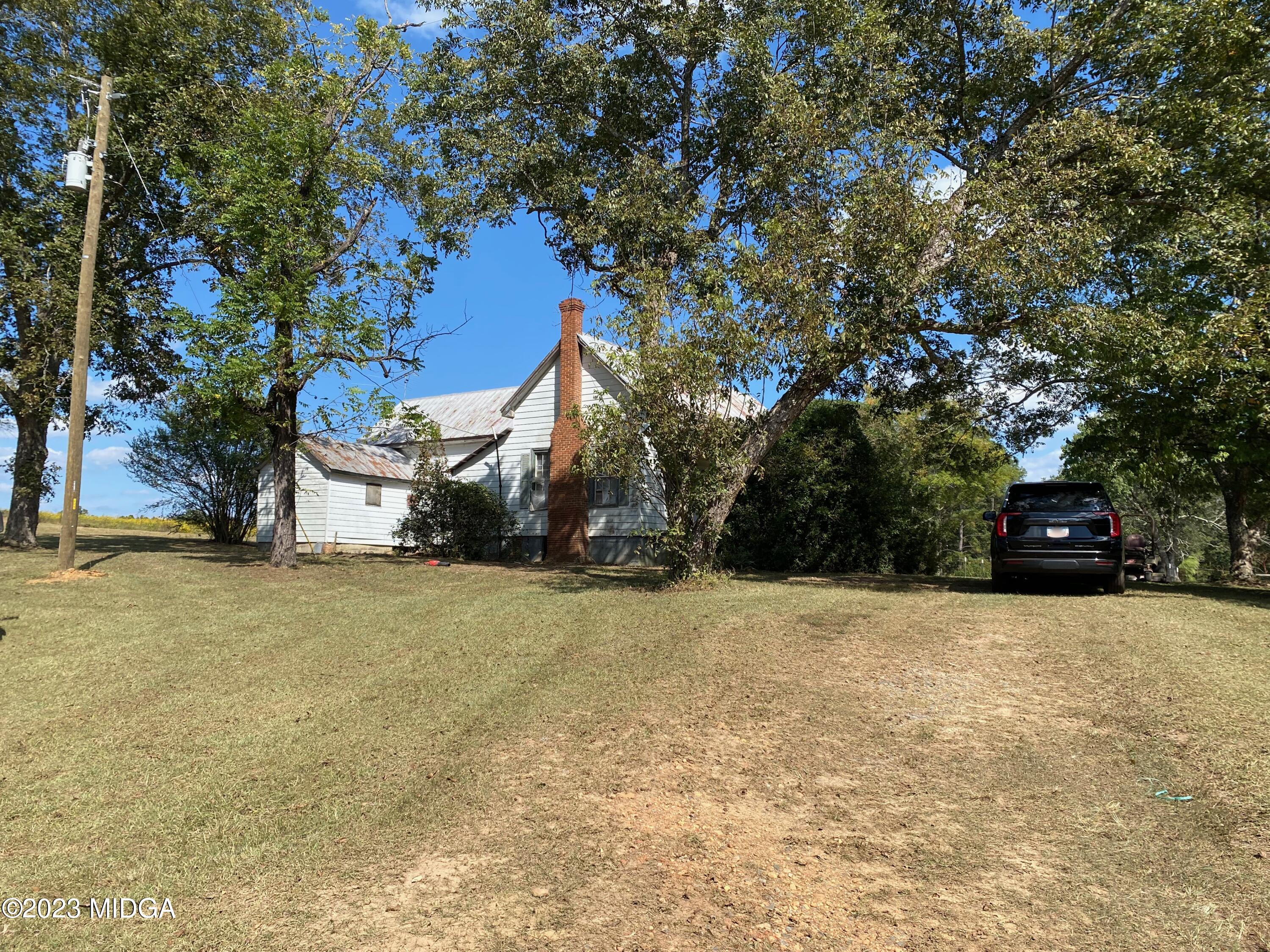 491 Barrow Road Reynolds, GA 31076 - Photo 25 of 56 a house with trees in front of it