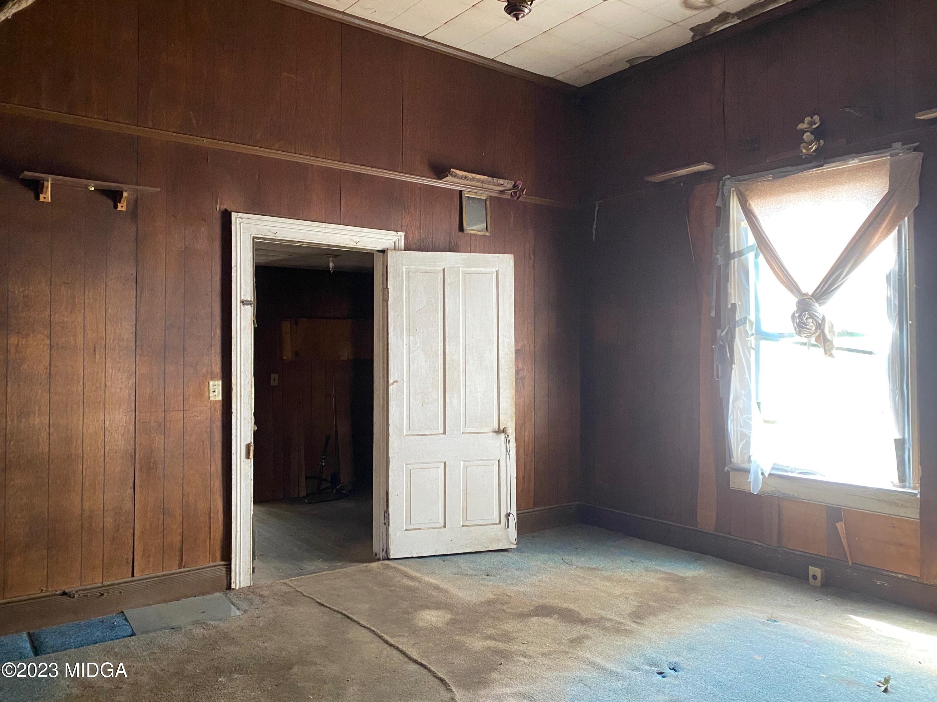 491 Barrow Road Reynolds, GA 31076 - Photo 7 of 56 a view of an empty room with a window