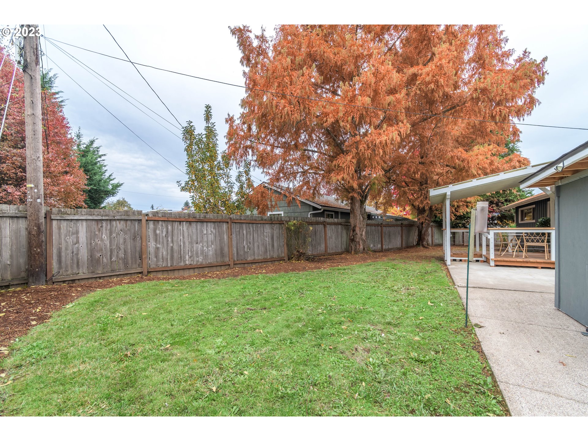 1730 Market Street Springfield, OR 97477 - Photo 32 of 43 a view of a backyard with table and chairs and wooden fence