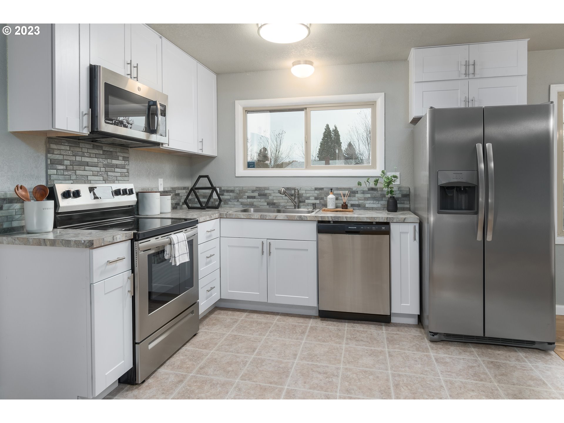 1730 Market Street Springfield, OR 97477 - Photo 8 of 43 a kitchen with stainless steel appliances granite countertop a stove a sink and a refrigerator