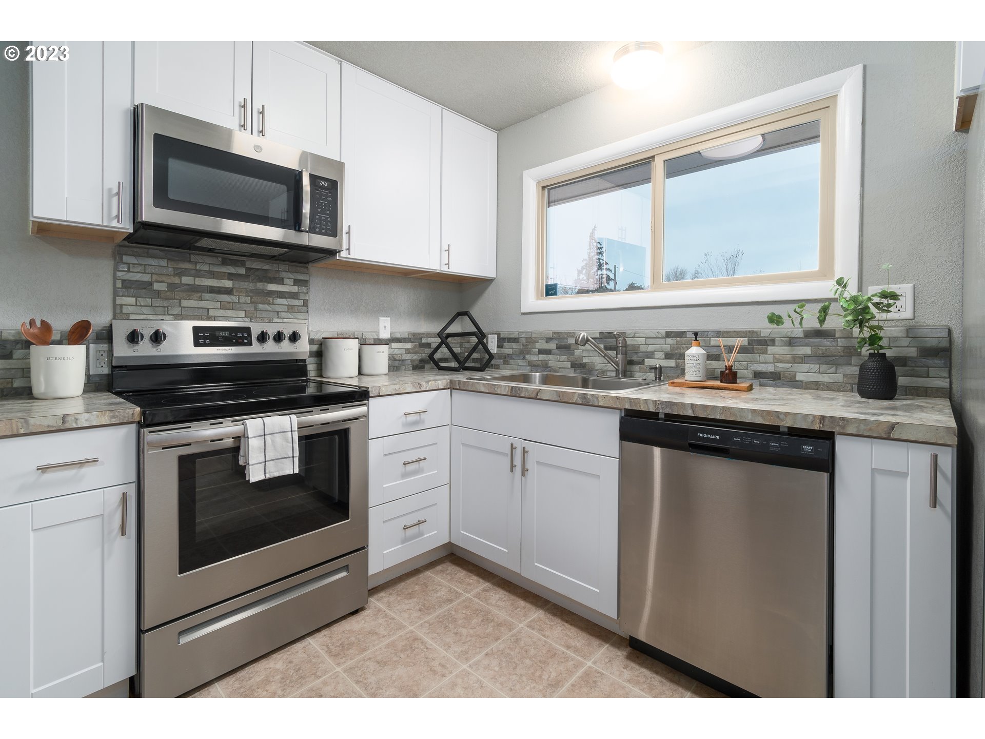 1730 Market Street Springfield, OR 97477 - Photo 9 of 43 a kitchen with stainless steel appliances granite countertop a stove a microwave a sink and cabinets
