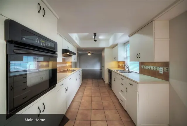 a large kitchen with granite countertop a stove and a refrigerator