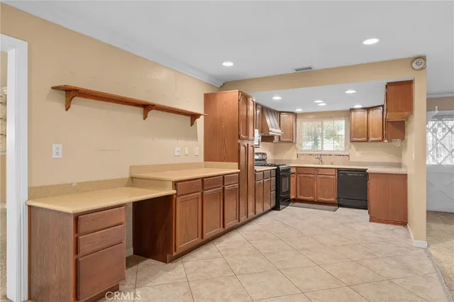a kitchen with a sink counter top space and stainless steel appliances