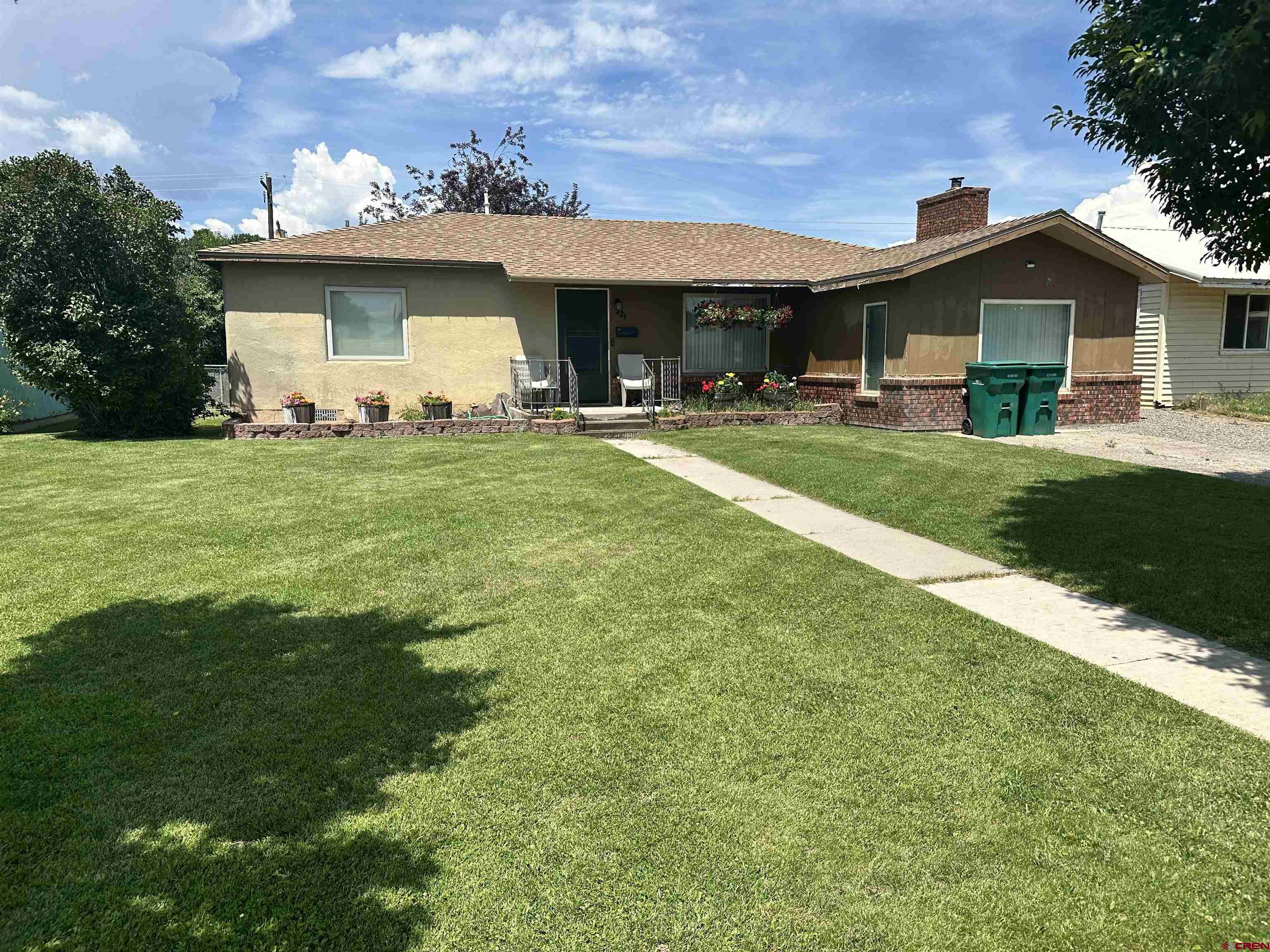 a front view of a house with a garden
