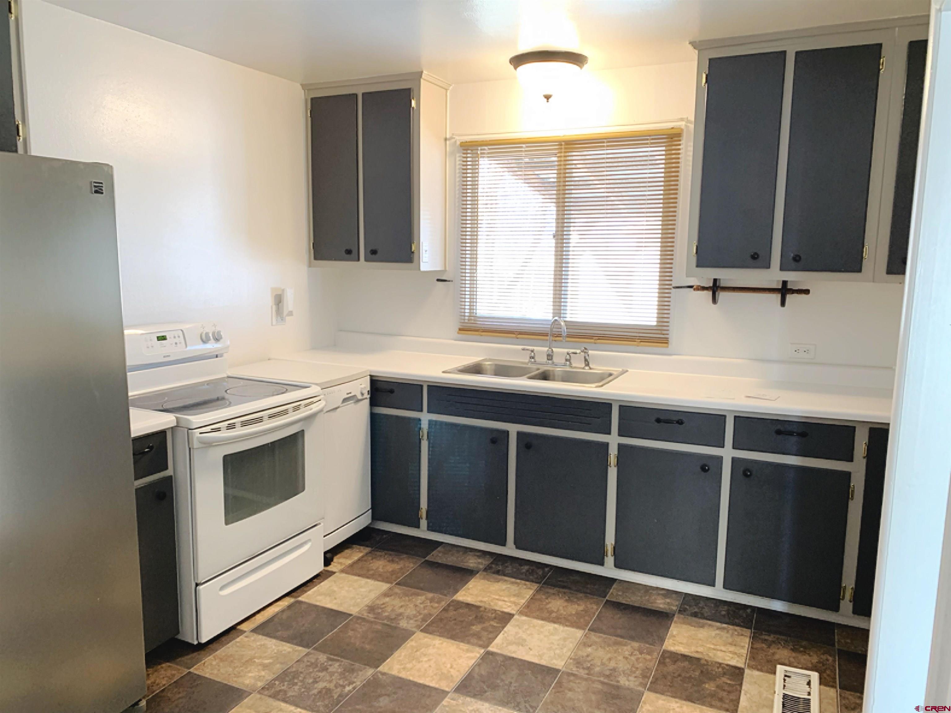 331 Morris Street Monte Vista, CO 81144 - Photo 11 of 31 a kitchen with a stove sink and window