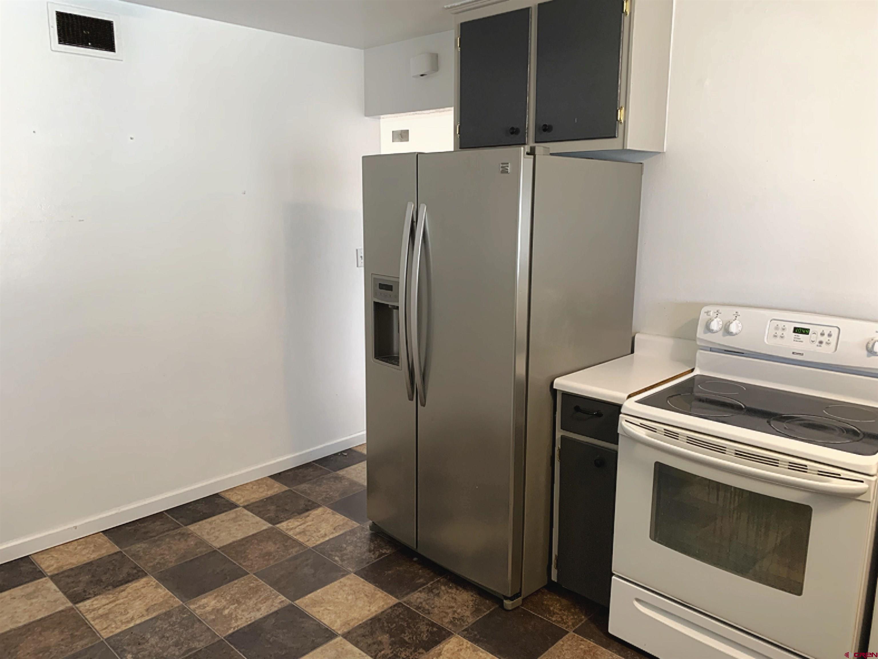 331 Morris Street Monte Vista, CO 81144 - Photo 12 of 31 a view of a kitchen with washer and dryer