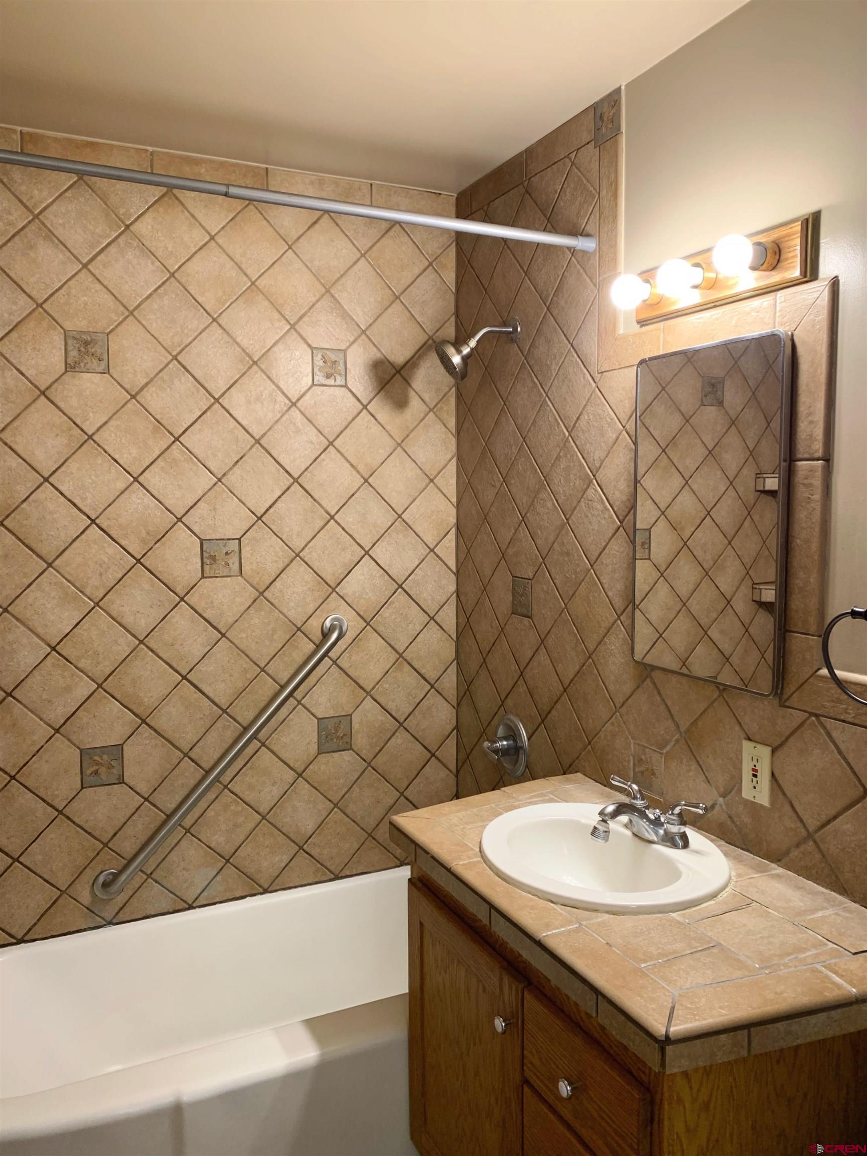 331 Morris Street Monte Vista, CO 81144 - Photo 16 of 31 a bathroom with a sink and a mirror