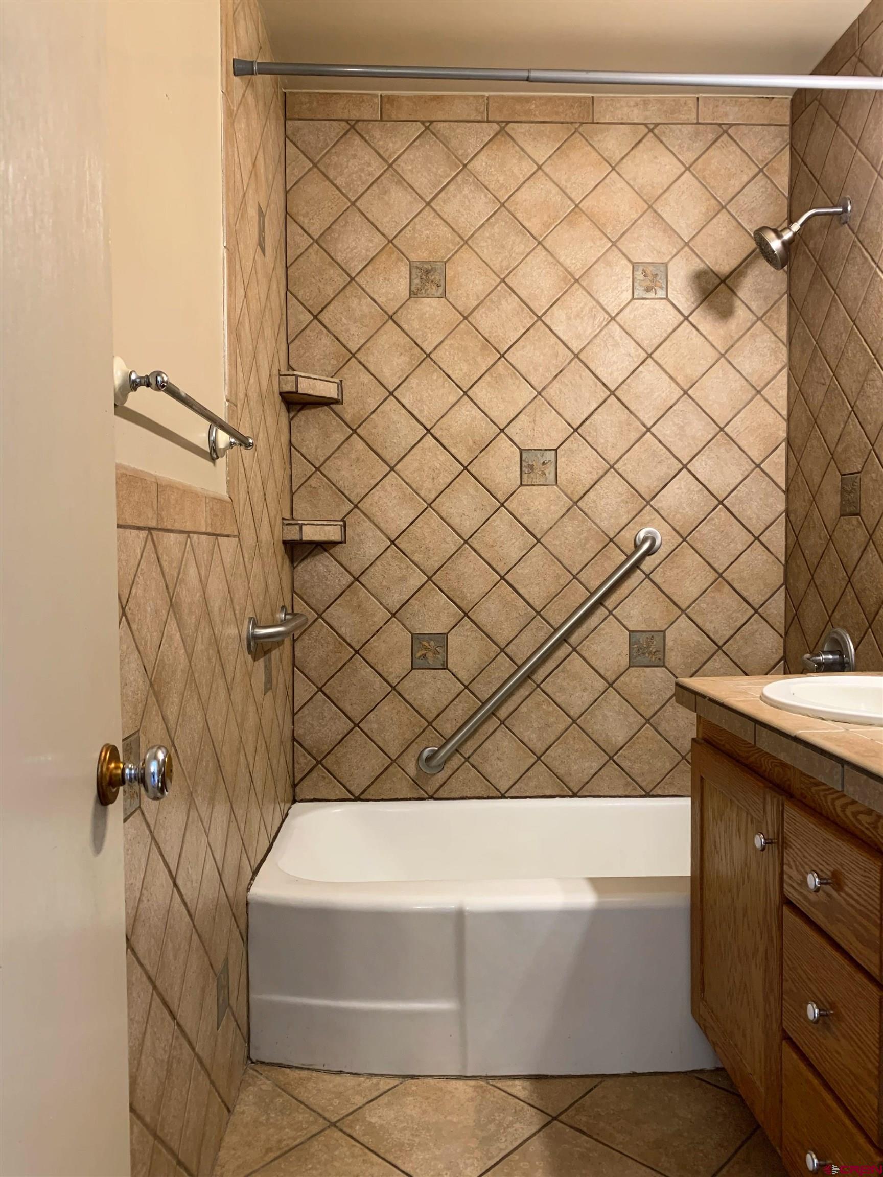331 Morris Street Monte Vista, CO 81144 - Photo 17 of 31 a bathroom with a bathtub and a shower
