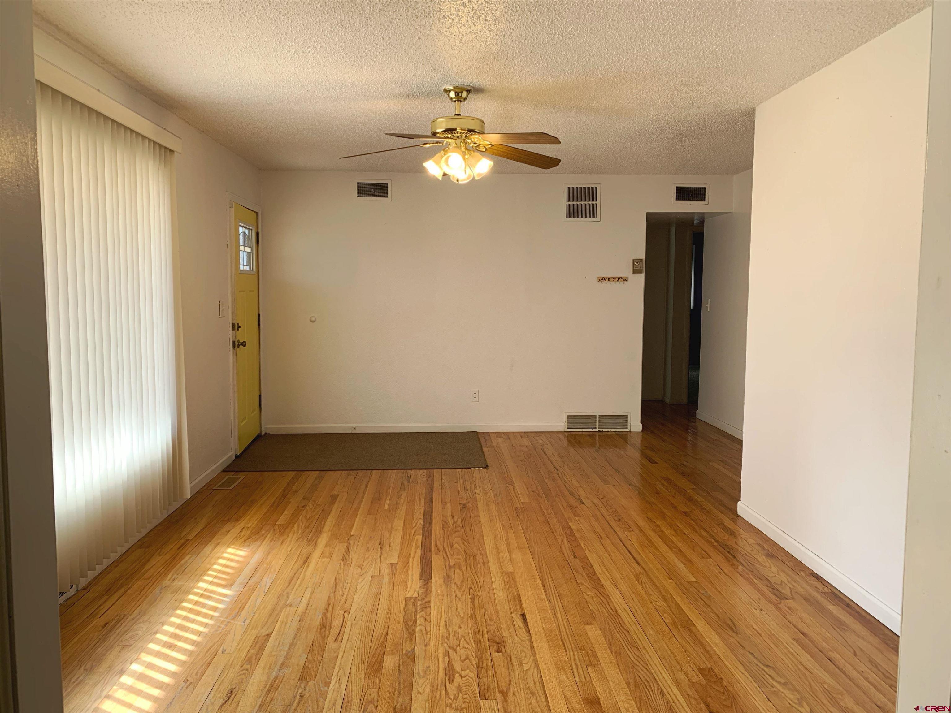 331 Morris Street Monte Vista, CO 81144 - Photo 3 of 31 a view of empty room with wooden floor