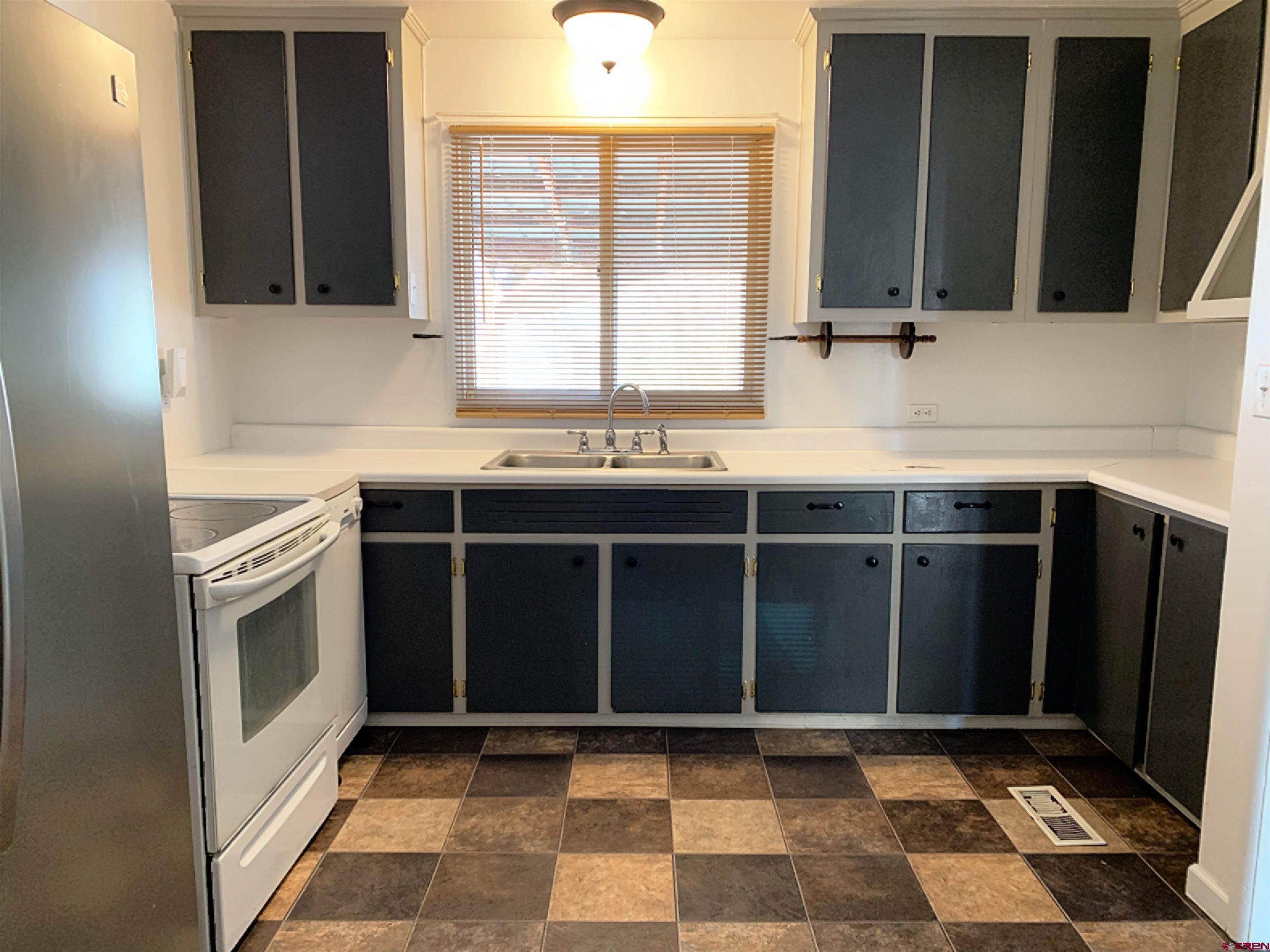 331 Morris Street Monte Vista, CO 81144 - Photo 10 of 31 a kitchen with a sink and a stove