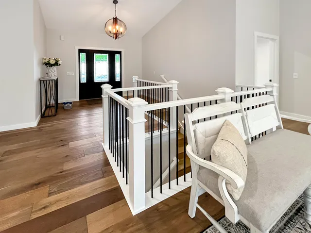 a view of entryway and hall with wooden floor