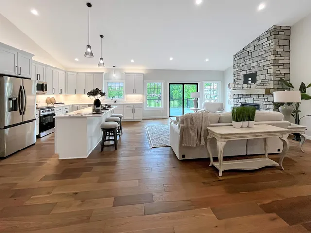 a view of an empty room and a kitchen