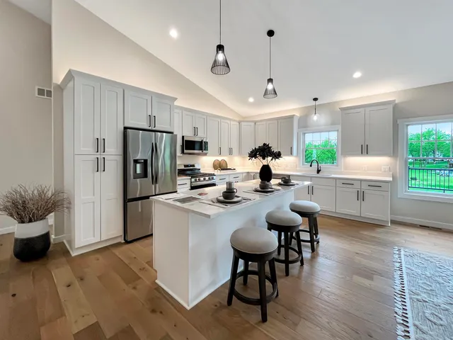 a aerial view of a house with a yard deck and furniture