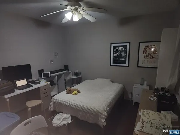 a bedroom with a bed and a chandelier