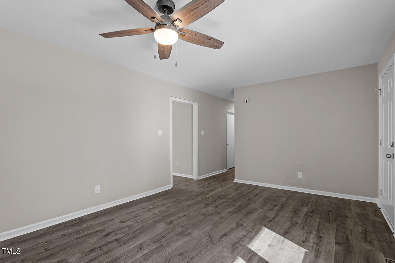 5137 Shield Circle Raleigh, NC 27603 - Photo 13 of 36 an empty room with wooden floor and ceiling fan