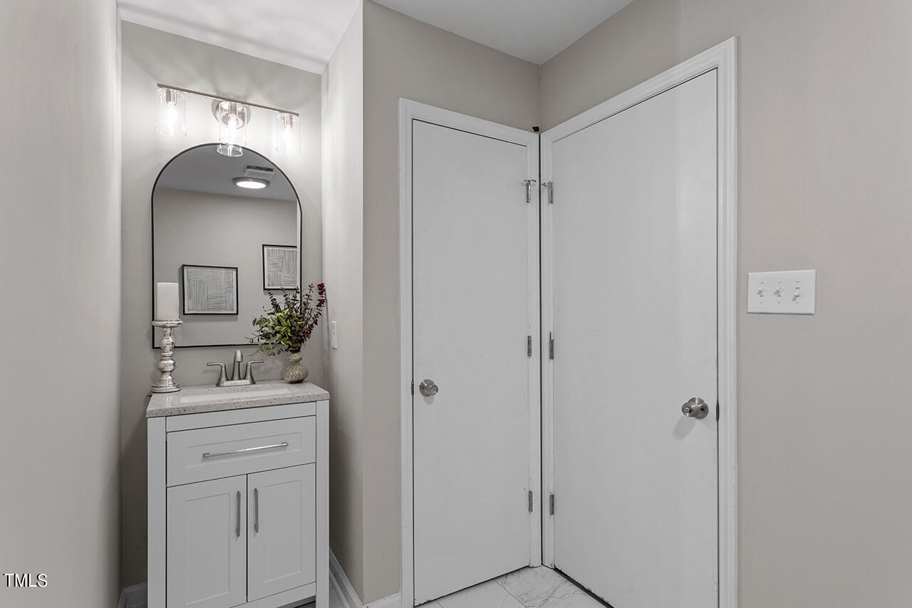 5137 Shield Circle Raleigh, NC 27603 - Photo 15 of 36 a bathroom with a sink and a mirror
