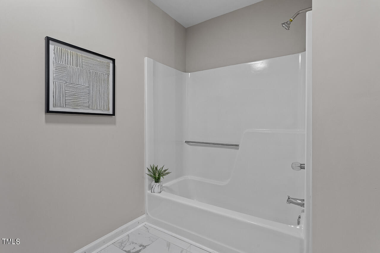 5137 Shield Circle Raleigh, NC 27603 - Photo 16 of 36 a bathroom with a bathtub