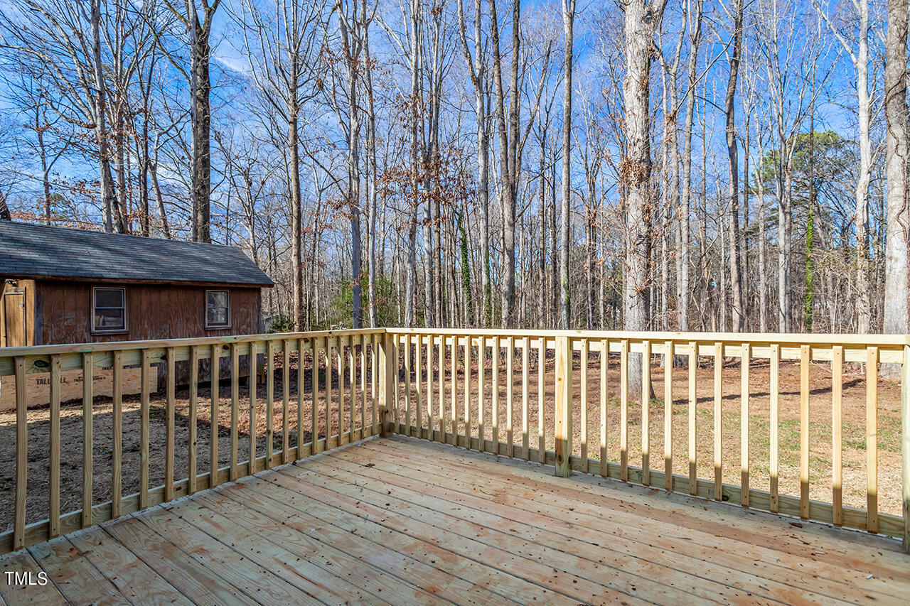 5137 Shield Circle Raleigh, NC 27603 - Photo 24 of 36 a view of a brick house with wooden fence