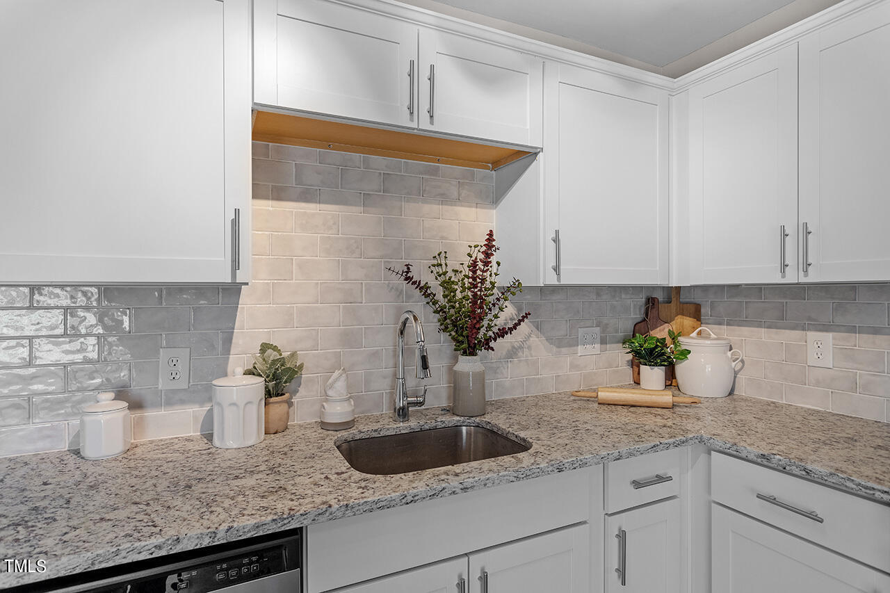 5137 Shield Circle Raleigh, NC 27603 - Photo 5 of 36 a kitchen with a sink and potted plant