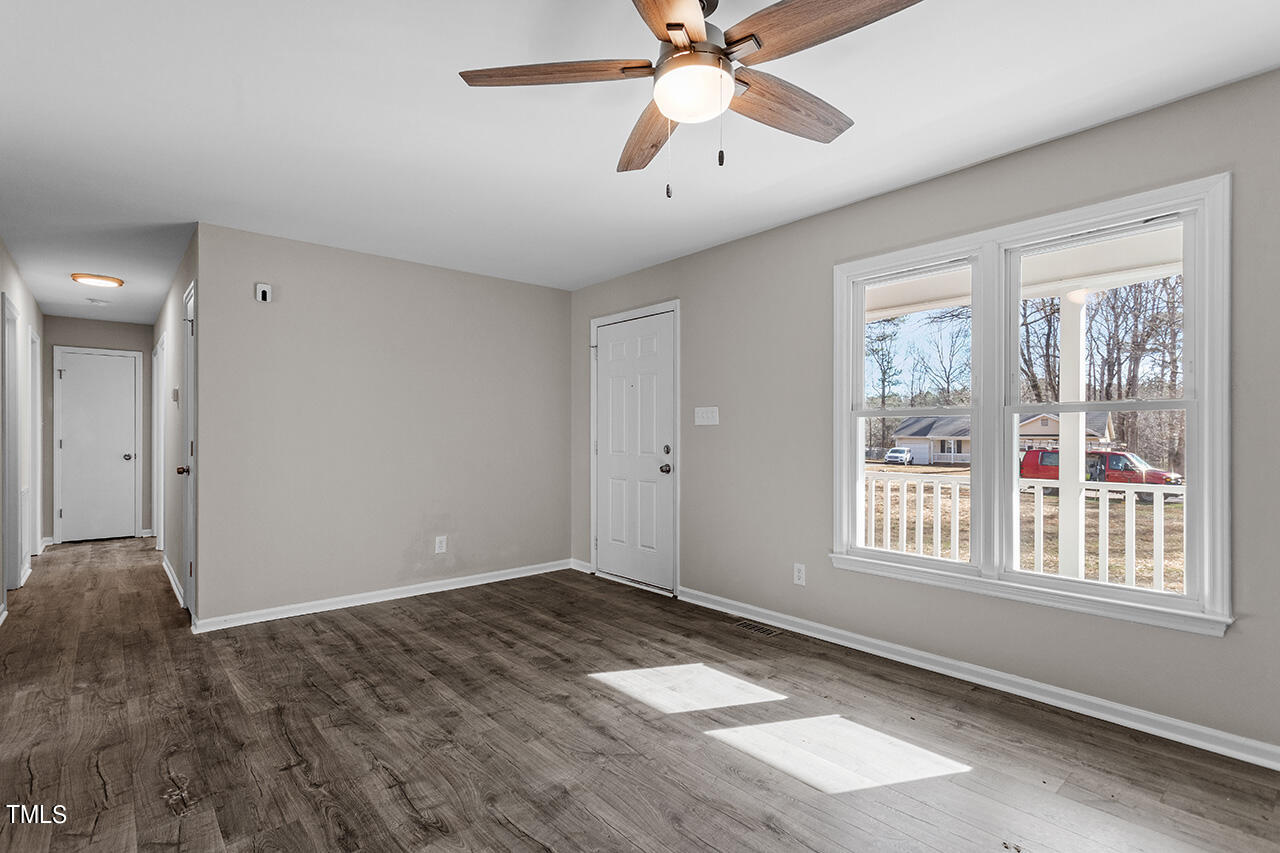 5137 Shield Circle Raleigh, NC 27603 - Photo 7 of 36 a view of an empty room with a window and wooden floor