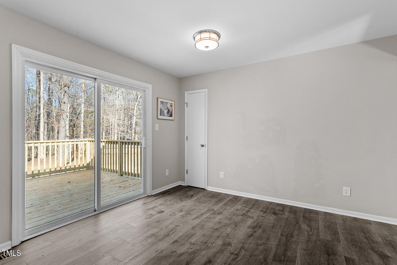 5137 Shield Circle Raleigh, NC 27603 - Photo 9 of 36 an empty room with wooden floor and windows