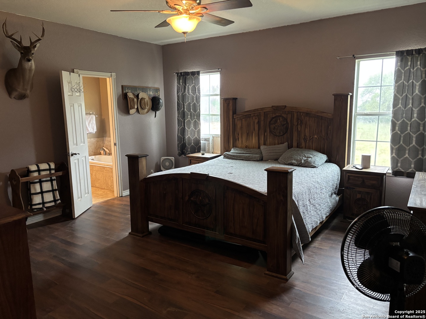 725 Lonesome Loop Blanco, TX 78606 - Photo 11 of 26 a bedroom with a bed and wooden floor