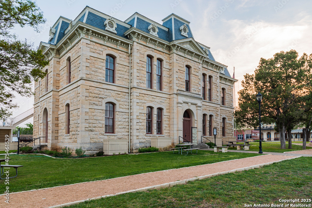 725 Lonesome Loop Blanco, TX 78606 - Photo 25 of 26 a front view of a house with a garden