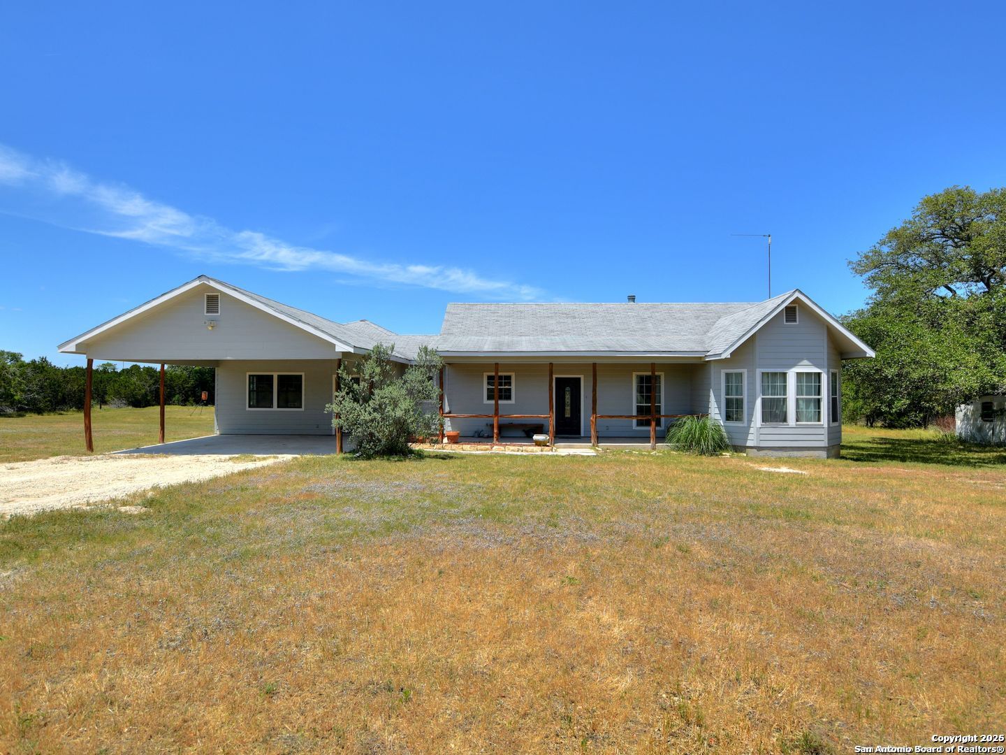 725 Lonesome Loop Blanco, TX 78606 - Photo 3 of 26 a front view of house with yard and trees