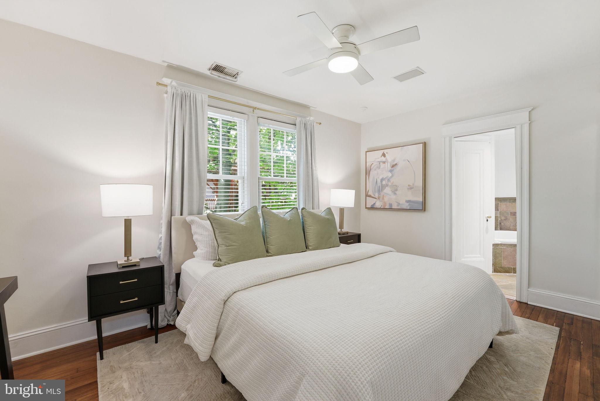 3512 30th Street Northwest Washington, DC 20008 - Photo 15 of 41 a bedroom with a large bed and a chandelier